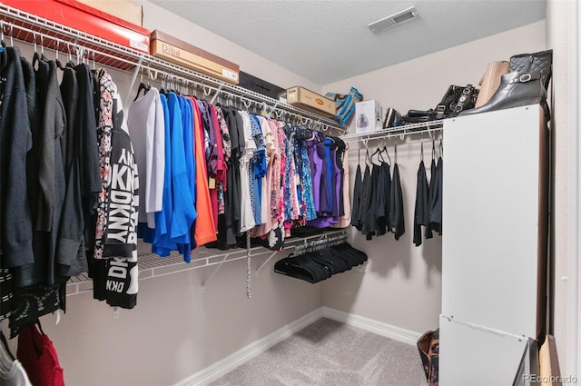 spacious closet with visible vents and carpet flooring