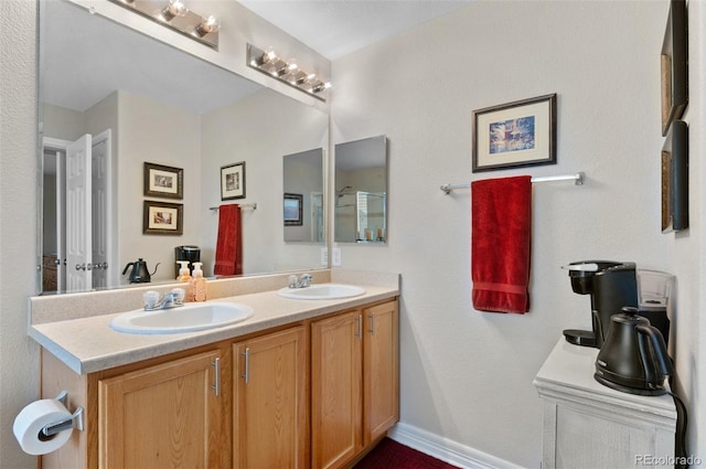 bathroom featuring a sink and double vanity