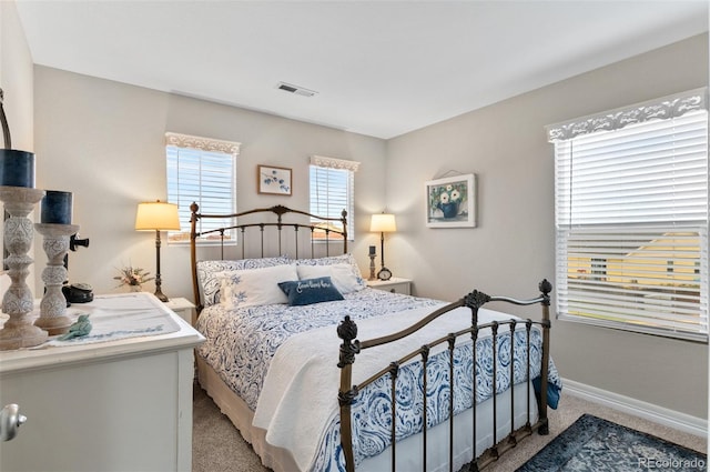 bedroom with light colored carpet, baseboards, and visible vents