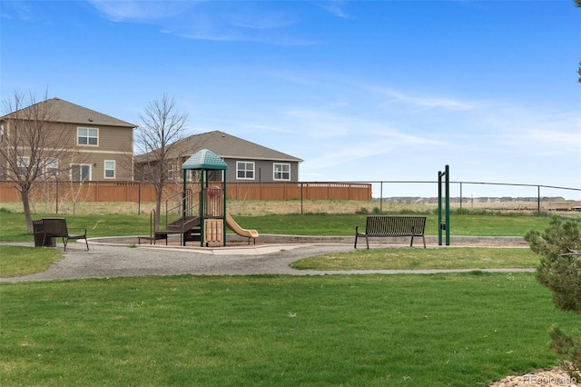 community playground with a lawn and fence
