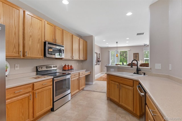201 Shenandoah Way, Brighton, CO 80603 - kitchen featuring appliances with stainless steel finishes, a sink, recessed lighting, light countertops, and a peninsula