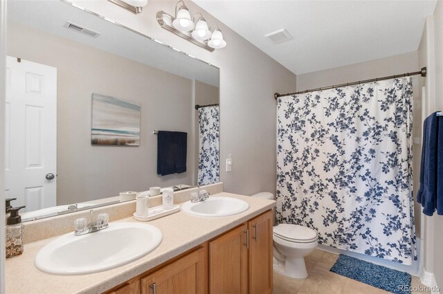201 Shenandoah Way, Brighton, CO 80603 - bathroom with toilet, double vanity, and a shower with curtain