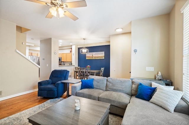 living room with hardwood / wood-style flooring and ceiling fan