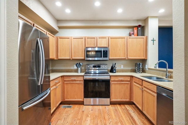 kitchen featuring light hardwood / wood-style floors, sink, stainless steel appliances, and light brown cabinets