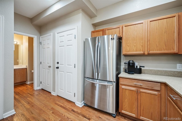 kitchen with stainless steel fridge and light wood-type flooring