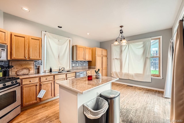 5136 S Ceylon St, Centennial, CO 80015 - kitchen with appliances with stainless steel finishes, light wood-type flooring, tasteful backsplash, a kitchen island, and recessed lighting