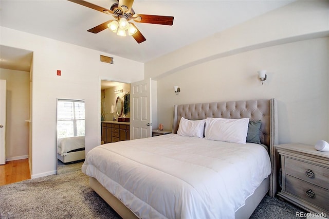 bedroom featuring light carpet, ceiling fan, connected bathroom, and baseboards