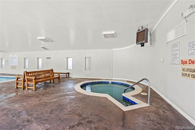 view of swimming pool featuring a hot tub and a pool