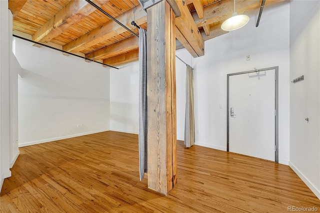 entrance foyer with wooden ceiling, light hardwood / wood-style flooring, and beamed ceiling