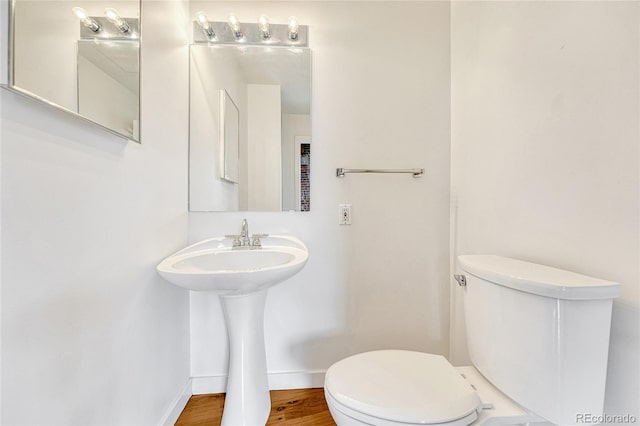 bathroom featuring toilet and wood-type flooring