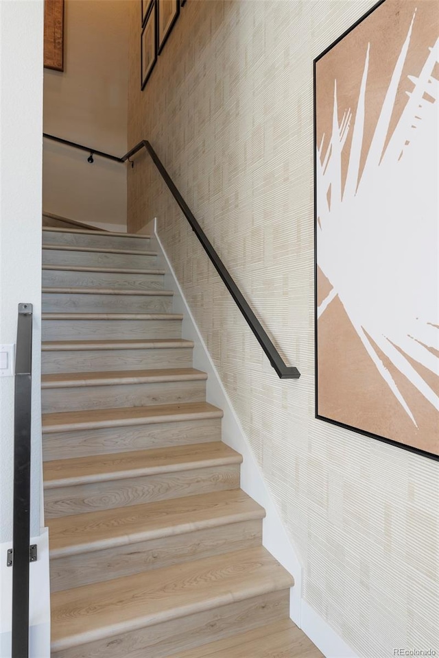 staircase with hardwood / wood-style flooring