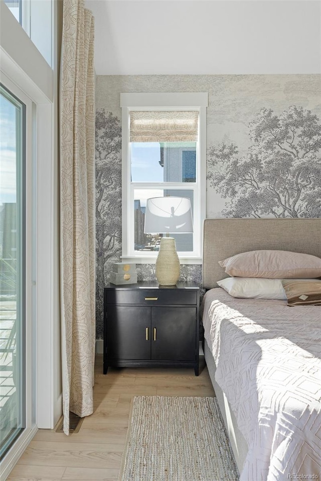 bedroom featuring light wood-type flooring and multiple windows