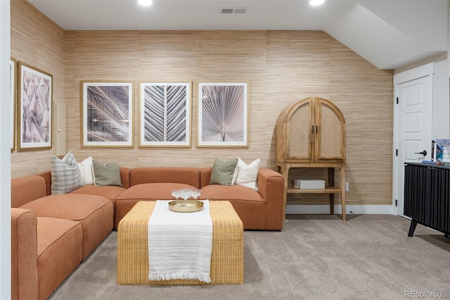 carpeted living room featuring lofted ceiling