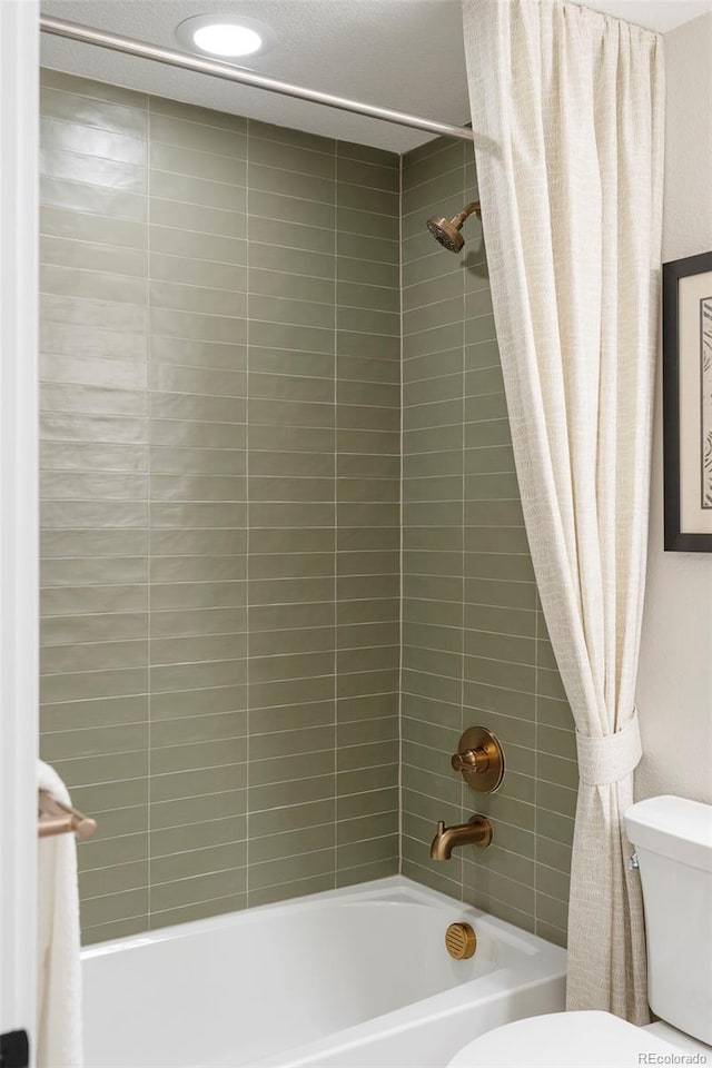 bathroom with shower / tub combo and toilet