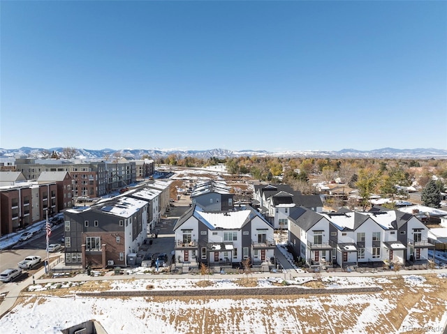 snowy aerial view with a mountain view