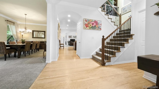 10328 Bluffmont Dr, Lone Tree, CO 80124 - foyer entrance featuring stairway, light wood-style floors, a chandelier, crown molding, and recessed lighting