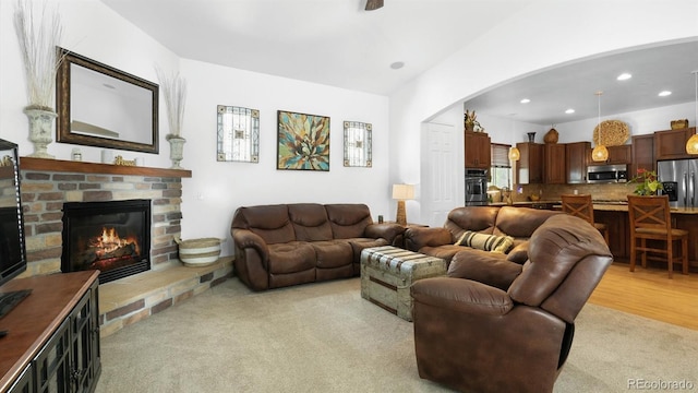 10328 Bluffmont Dr, Lone Tree, CO 80124 - living room with light carpet, arched walkways, a brick fireplace, and recessed lighting