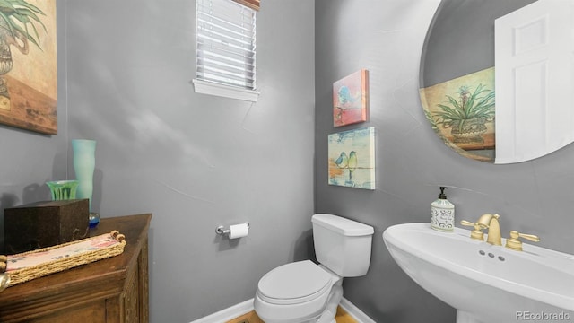 10328 Bluffmont Dr, Lone Tree, CO 80124 - half bath featuring a sink and toilet