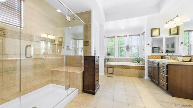 10328 Bluffmont Dr, Lone Tree, CO 80124 - full bath featuring a garden tub, vanity, plenty of natural light, and tile patterned floors
