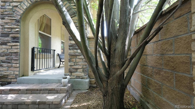 10328 Bluffmont Dr, Lone Tree, CO 80124 - doorway to property with stone siding and brick siding