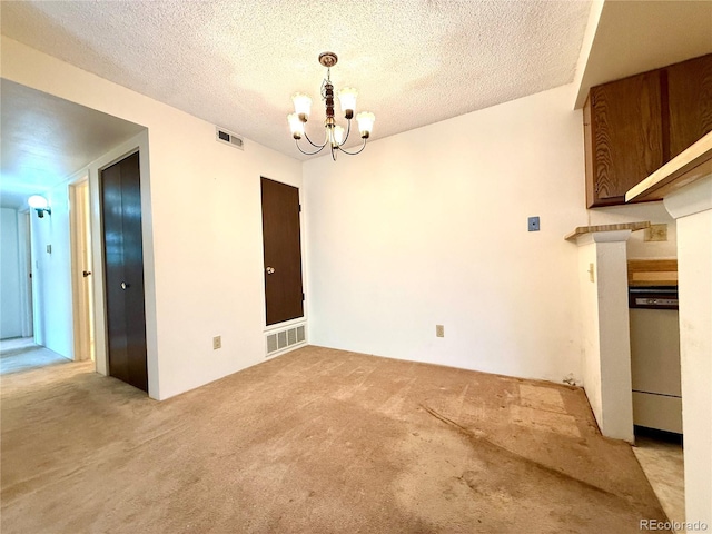 1870 S Pitkin Cir Unit B, Aurora, CO 80017 - unfurnished dining area with light colored carpet, a chandelier, and a textured ceiling