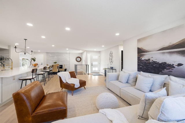 living room featuring sink and light hardwood / wood-style floors