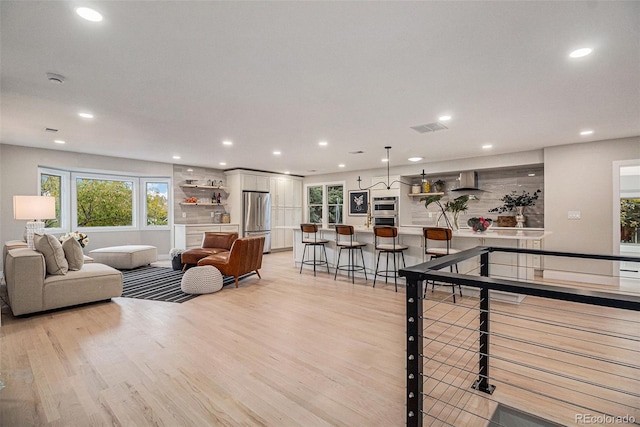 recreation room featuring light wood-type flooring