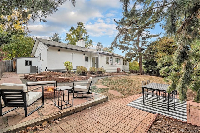 view of patio featuring a fire pit and central air condition unit