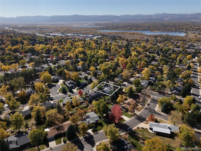 drone / aerial view with a water and mountain view