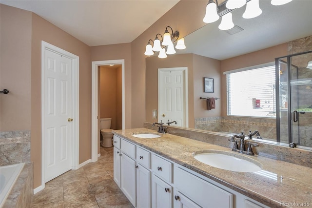 full bathroom featuring a garden tub, toilet, a stall shower, and a sink