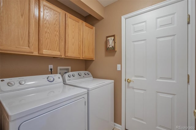 washroom with cabinet space and washing machine and clothes dryer