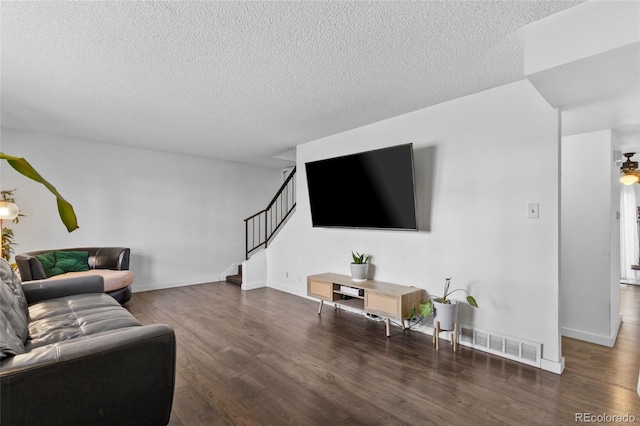 9044 E Nassau Ave, Denver, CO 80237 - living room with stairs, wood finished floors, a textured ceiling, and baseboards