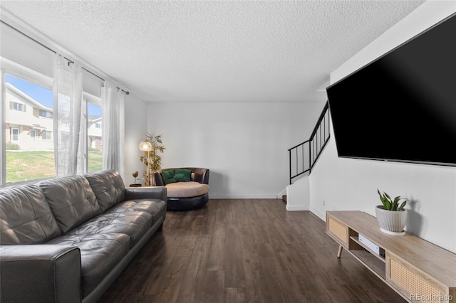 9044 E Nassau Ave, Denver, CO 80237 - living room with wood finished floors, a textured ceiling, stairs, and baseboards