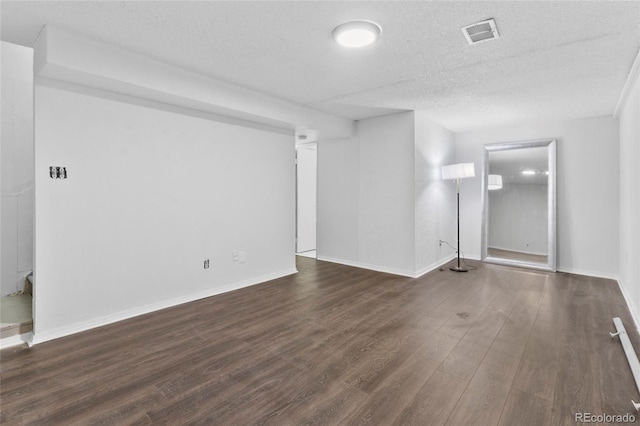 9044 E Nassau Ave, Denver, CO 80237 - unfurnished room with a textured ceiling, wood finished floors, and baseboards