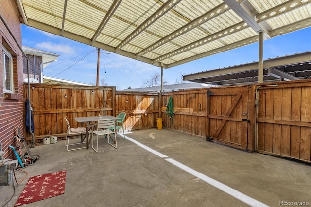 9044 E Nassau Ave, Denver, CO 80237 - view of patio with a gate, outdoor dining space, and fence