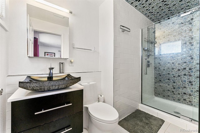 6267 S Josephine Way, Centennial, CO 80121 - bathroom with a shower stall, vanity, tile walls, and tile patterned floors