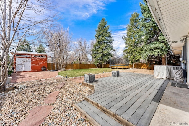 6267 S Josephine Way, Centennial, CO 80121 - wooden terrace featuring a trampoline and a fenced backyard
