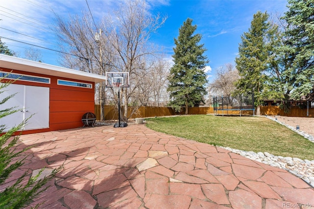 6267 S Josephine Way, Centennial, CO 80121 - fenced backyard featuring a trampoline and a patio area