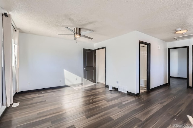 unfurnished room with a textured ceiling, ceiling fan, and dark hardwood / wood-style floors