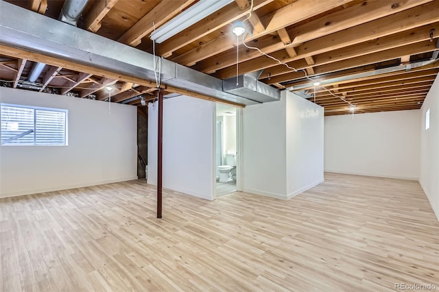 basement with light hardwood / wood-style floors