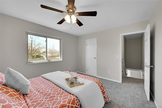 carpeted bedroom with a ceiling fan and baseboards
