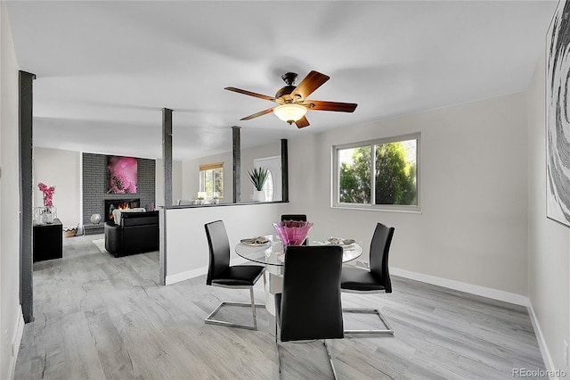 dining area featuring plenty of natural light, baseboards, and a fireplace