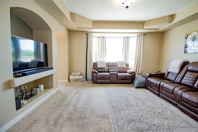 carpeted living room featuring built in shelves