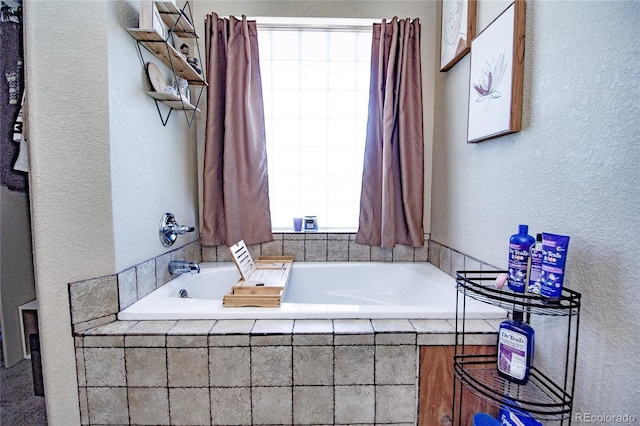 bathroom featuring a relaxing tiled tub