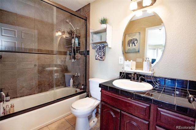 full bathroom with enclosed tub / shower combo, vanity, tile patterned floors, and toilet