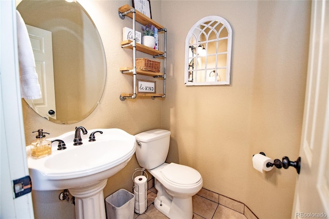 bathroom featuring sink, tile patterned floors, and toilet