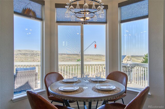 4142 S Deframe Ct, Morrison, CO 80465 - dining space with a textured wall and a notable chandelier