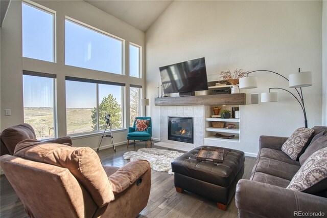 4142 S Deframe Ct, Morrison, CO 80465 - living room with high vaulted ceiling, baseboards, a tile fireplace, and wood finished floors