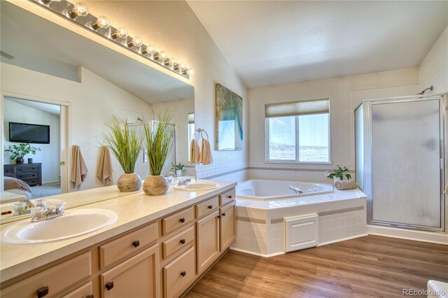 4142 S Deframe Ct, Morrison, CO 80465 - bathroom featuring a sink, double vanity, a bath, and lofted ceiling