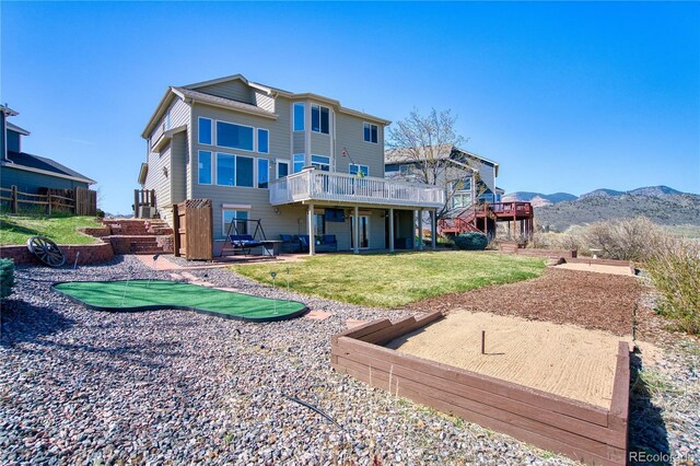 4142 S Deframe Ct, Morrison, CO 80465 - rear view of property with a lawn and a deck with mountain view
